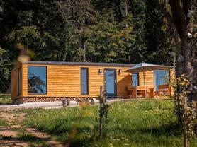 Mobilní dům Super Arktik ® Wood Super Arktik ® se dvěma oddělenými ložnicemi, obývacím pokojem spojeným s koupelnou a luxusní koupelnou.